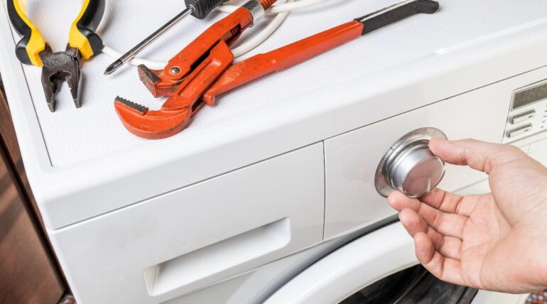A homeowner troubleshooting a refrigerator with DIY appliance repair tips.