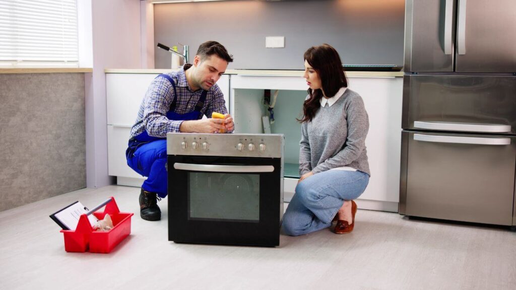 Professional technician performing appliance maintenance to extend lifespan and save money.