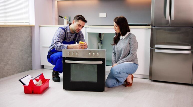 Professional technician performing appliance maintenance to extend lifespan and save money.