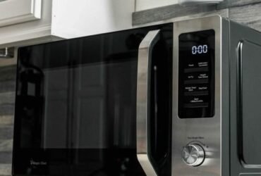 Technician testing microwave buttons that are not working.