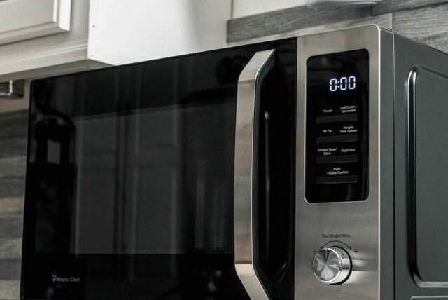 Technician testing microwave buttons that are not working.