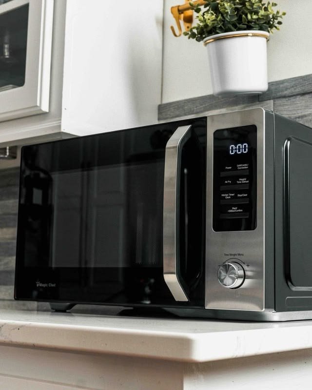 Technician testing microwave buttons that are not working.